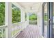 Charming porch with dark wood flooring, white columns, and view of the yard at 1160 Foster Nw Pl, Atlanta, GA 30318