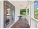 Charming porch with dark wood flooring, white columns, and view of the yard at 1160 Foster Nw Pl, Atlanta, GA 30318