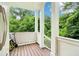 Inviting porch with classic white columns overlooking lush green trees at 1160 Foster Nw Pl, Atlanta, GA 30318