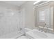 Bathroom features marble tiled shower, vanity, and decorative mirror at 1594 Pine Glen Cir, Decatur, GA 30035