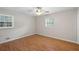 Bedroom featuring hardwood floors, a ceiling fan, and natural light from two windows at 1594 Pine Glen Cir, Decatur, GA 30035