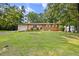Beautiful home featuring a spacious front yard, attached garage, and a mix of brick and siding at 1594 Pine Glen Cir, Decatur, GA 30035