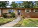 Inviting front entrance with a classic door, brick accents, and well-maintained landscaping at 1594 Pine Glen Cir, Decatur, GA 30035
