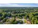 Aerial view of homes nestled among mature trees, showcasing a serene neighborhood setting at 314 Savannah Pl, Loganville, GA 30052