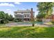 Spacious backyard with a pool, lush lawn, and a charming two-story home with an enclosed sunroom at 314 Savannah Pl, Loganville, GA 30052