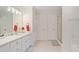 Bright bathroom with white cabinets, double doors, and a shower with glass doors at 314 Savannah Pl, Loganville, GA 30052
