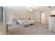 Bright bedroom with neutral carpet, ceiling fan, and storage under the bed at 314 Savannah Pl, Loganville, GA 30052