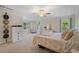 Large bedroom with neutral colored carpet, many windows, and a ceiling fan at 314 Savannah Pl, Loganville, GA 30052