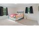 Bright bedroom with large windows and hardwood floors at 314 Savannah Pl, Loganville, GA 30052