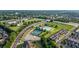An aerial view of a community, featuring a pool, tennis courts, and well-maintained townhomes in a green setting at 314 Savannah Pl, Loganville, GA 30052