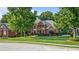 Charming two-story brick home with a lush green lawn and mature trees at 314 Savannah Pl, Loganville, GA 30052