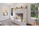 Living room fireplace featuring decor, windows, and hardwood floors at 314 Savannah Pl, Loganville, GA 30052