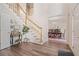 Elegant foyer with hardwood floors and staircase adjacent to the formal dining room at 314 Savannah Pl, Loganville, GA 30052