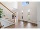 Bright foyer with hardwood floors, staircase, and large windows, creating a welcoming entrance at 314 Savannah Pl, Loganville, GA 30052