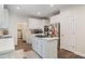 Bright kitchen with white cabinets, center island, and stainless steel appliances at 314 Savannah Pl, Loganville, GA 30052