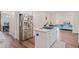 Spacious kitchen with stainless steel appliances, a center island, and hardwood floors at 314 Savannah Pl, Loganville, GA 30052