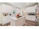 Spacious kitchen featuring white cabinets, a gas cooktop, and ample counter space at 314 Savannah Pl, Loganville, GA 30052