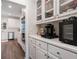 Bright kitchen featuring white cabinets, stainless steel appliances, and hardwood floors at 314 Savannah Pl, Loganville, GA 30052
