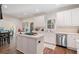 Kitchen with island cooktop, stainless steel appliances, and bright lighting at 314 Savannah Pl, Loganville, GA 30052