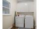 Laundry room featuring a washer, dryer, cabinets, and a window at 314 Savannah Pl, Loganville, GA 30052