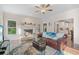 Bright living room featuring a fireplace, ceiling fan, and hardwood floors at 314 Savannah Pl, Loganville, GA 30052