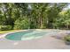 Private backyard pool surrounded by lush greenery and lounge chairs for relaxation and enjoyment at 314 Savannah Pl, Loganville, GA 30052