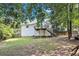 Large backyard featuring a well-maintained lawn and mature trees, providing a serene outdoor retreat at 47 Glen Ridge Dr, Villa Rica, GA 30180