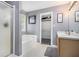 Bathroom featuring a combination tub and shower, dual sink vanity, and a walk in closet at 47 Glen Ridge Dr, Villa Rica, GA 30180