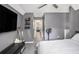 A bedroom with gray walls, a ceiling fan, and a glimpse into a brightly lit hallway at 47 Glen Ridge Dr, Villa Rica, GA 30180
