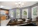 Bright eat-in dining area with plenty of natural light, a dark wood table, and views of the backyard at 47 Glen Ridge Dr, Villa Rica, GA 30180