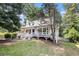 Charming two-story home with white siding, a lovely porch, and mature trees at 47 Glen Ridge Dr, Villa Rica, GA 30180
