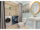 Convenient laundry area with washer, dryer, shelving, and unique blue-painted accent at 47 Glen Ridge Dr, Villa Rica, GA 30180