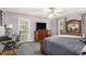 Spacious main bedroom includes a walkout to a private deck and a decorative ceiling fan at 47 Glen Ridge Dr, Villa Rica, GA 30180