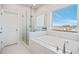 Well-lit bathroom with a soaking tub, a glass enclosed shower, and a window with an outside view at 5217 Riden Ct # 263, Buford, GA 30518