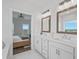 Spacious bathroom featuring double sink vanity and mirror, with a view into the bedroom at 5217 Riden Ct # 263, Buford, GA 30518