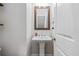 Stylish half-bathroom featuring a sleek pedestal sink and wood framed mirror at 5217 Riden Ct # 263, Buford, GA 30518