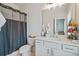 Bright bathroom featuring a toilet, vanity, and a tub with a shower at 5217 Riden Ct # 263, Buford, GA 30518