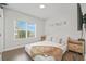 Well-lit bedroom with a large window, and minimalist decor at 5217 Riden Ct # 263, Buford, GA 30518