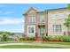 Charming brick townhouse with blue door, complemented by a well-manicured lawn and lush landscaping at 5217 Riden Ct # 263, Buford, GA 30518