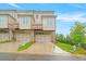 Modern townhome with rear garages, wooden decks, and well-manicured lawn at 5217 Riden Ct # 263, Buford, GA 30518