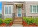 Inviting front entrance showcasing a blue door, brick steps, and professional landscaping at 5217 Riden Ct # 263, Buford, GA 30518
