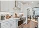 Well-equipped kitchen with modern appliances, white cabinets, and sleek countertops at 5217 Riden Ct # 263, Buford, GA 30518
