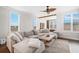 Spacious living room featuring a sectional sofa and an abundance of natural light from the many windows at 5217 Riden Ct # 263, Buford, GA 30518