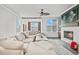 Bright living room featuring a large sectional sofa, fireplace, and views from the many windows at 5217 Riden Ct # 263, Buford, GA 30518