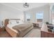 Comfortable main bedroom featuring a large bed, natural light, and neutral tones for a relaxing ambiance at 5217 Riden Ct # 263, Buford, GA 30518