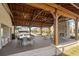 Outdoor covered seating area with ceiling fans, stone fireplace, and outdoor kitchen at 5217 Riden Ct # 263, Buford, GA 30518