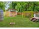 Large backyard featuring a tool shed, pergola, and fire pit, perfect for outdoor enjoyment and entertainment at 747 Dill Sw Ave, Atlanta, GA 30310