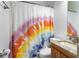 This bathroom features granite counters, a mirror, and decorative shower curtain at 747 Dill Sw Ave, Atlanta, GA 30310