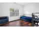 Cozy bedroom features hardwood floors, neutral walls, and large window at 747 Dill Sw Ave, Atlanta, GA 30310