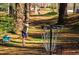 Disc golf course with player throwing a disc towards the metal basket at 747 Dill Sw Ave, Atlanta, GA 30310